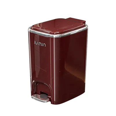 A red pedal trash can with a silver pedal and trim, shown against a white background.