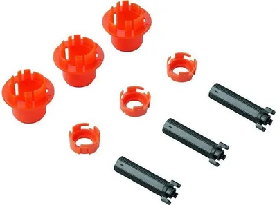 A collection of plumbing parts, including orange plastic connectors and gray metal tubes, arranged on a white background.