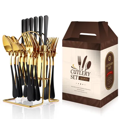 A cutlery set in a gold holder next to its packaging.