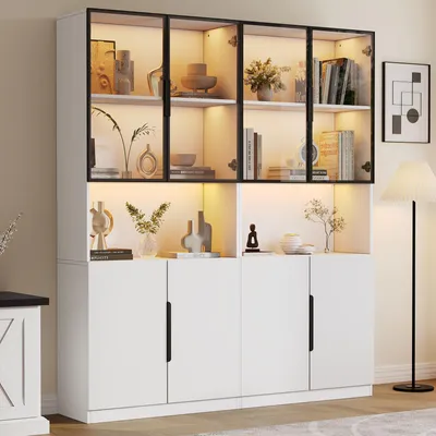 A modern white display cabinet with glass doors and internal LED lighting, showcasing various decorative items and books.
