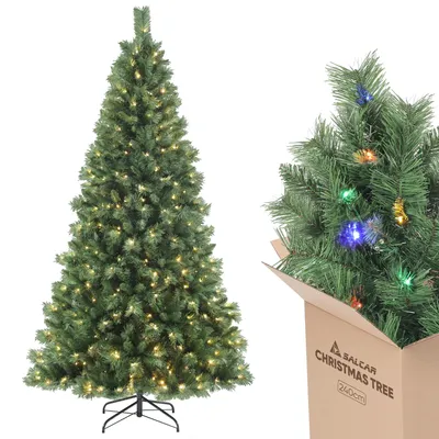 A Christmas tree with lights and a cardboard box with another Christmas tree inside.