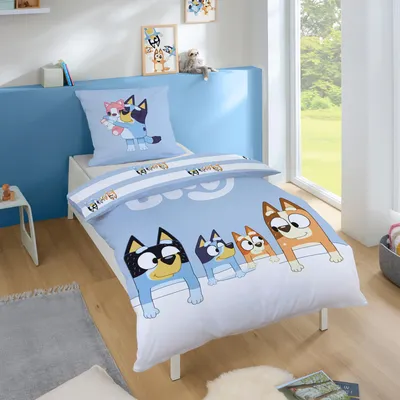 A child's bedroom with a bed featuring Bluey-themed bedding.