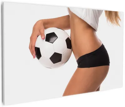 Produktbild von Wallario Premium Leinwandbild Fußball - sexy Frau mit einem Fußball in Größe 60 x 90 cm