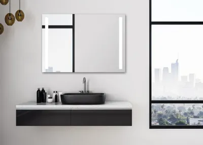 A modern bathroom vanity with a sink and a lighted mirror, with a city view through a large window.