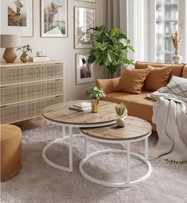 A living room scene with a couch, coffee tables, and decor.