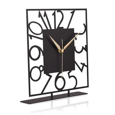 A decorative black metal clock with gold hands on a white background.