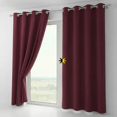 A close-up view of two burgundy curtains hanging on a window rod, with one curtain partially open to reveal a window with a landscape view.