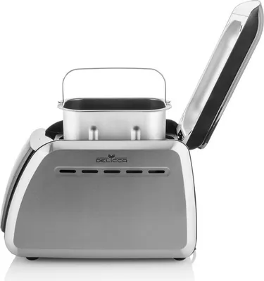 A silver bread maker with its lid open, showing the bread pan inside.