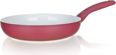 A red frying pan with a white interior and a red handle is shown against a white background.