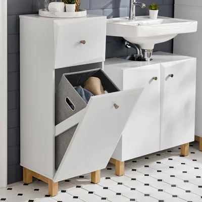A white laundry cabinet with a pull-out laundry basket next to a sink in a bathroom.