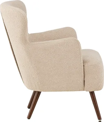Side view of a beige armchair with wooden legs.