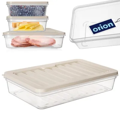 A collection of clear plastic food storage containers with beige lids, some filled with food items like blueberries, cheese, and ham, and one container with a branded tag.