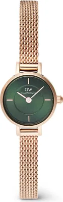 A close-up studio shot of a Daniel Wellington watch with a green dial and rose gold mesh strap, presented against a white background.