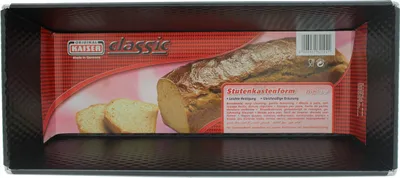 The image shows a loaf pan with product packaging inside. The packaging features an image of a loaf of bread and descriptive text.