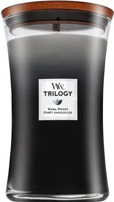 A tall, dark glass candle with a wooden lid.