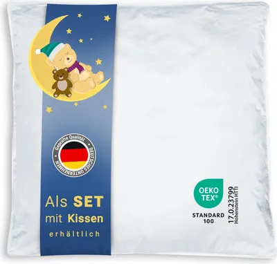 A white pillowcase with a blue band featuring a teddy bear on a moon, stars, German flag seal, and text.