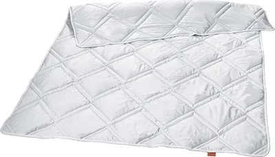 A white quilted duvet is laid out flat on a white background.