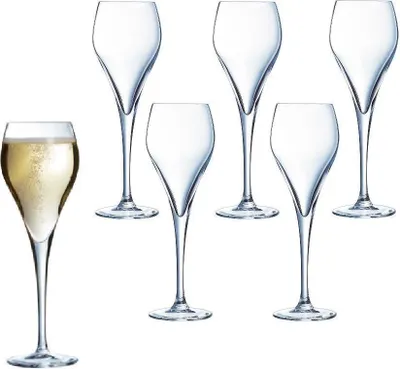 A set of champagne flutes, with one flute filled with champagne.