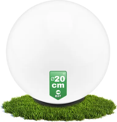 A white spherical lamp sits on a patch of artificial grass.