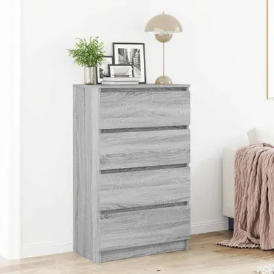 A gray wooden chest of drawers with four drawers is shown in a room.