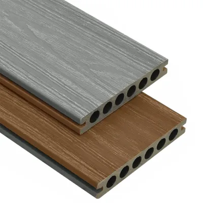 Two composite decking boards with a wood grain texture, one gray and one brown, are shown stacked diagonally against a white background. The boards have hollow cores visible on the cut ends.