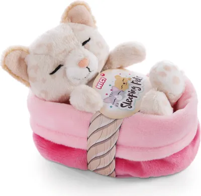 A plush toy kitten sleeping in a pink bed.