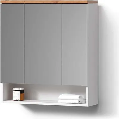 A bathroom cabinet with mirrored doors and a shelf below, displaying a jar and folded towels.