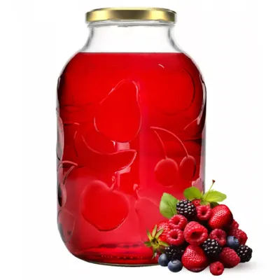 A large glass jar filled with red liquid, with a pile of mixed berries in front of it.