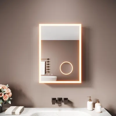 A modern bathroom vanity with a lit mirror, sink, and soap dispensers.