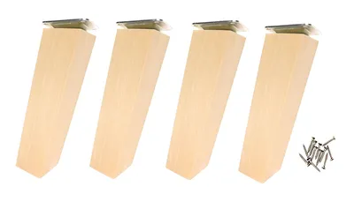Four wooden furniture legs with metal mounting plates and a pile of screws on a white background.