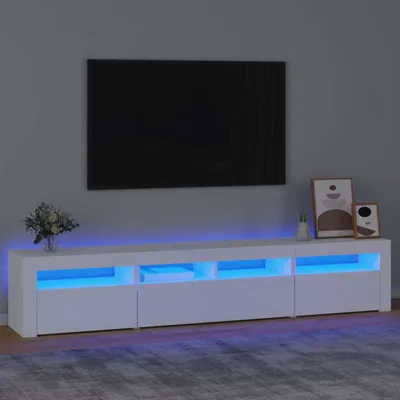A modern white TV stand with blue LED lighting is shown in a living room setting, with a large black TV mounted on the wall above it.