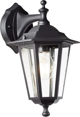 A black outdoor wall lantern with clear glass panels and a visible light bulb.