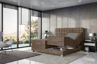 A modern bedroom with a large window overlooking a scenic view, featuring an adjustable bed.