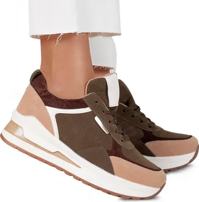 Close-up shot of women's sneakers worn by a person.