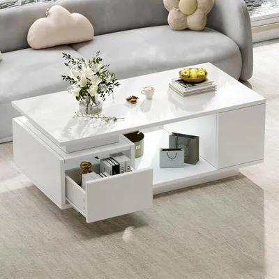 A white coffee table with drawers and shelves in a living room setting.