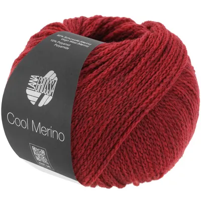 A ball of red yarn with a label wrapped around it.