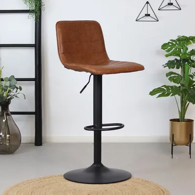A brown leather bar stool with a black metal base is shown in a room with plants and decorative items.