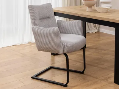 Produktbild von Hera - Polsterstuhl im modernen Design aus grauem Cord mit Armlehnen und Freischwinger-Gestell aus schwarzem Metall