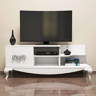 A white TV stand with a TV on top, and decorative items on the shelves.