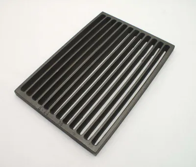 A cast iron grill grate on a white background.