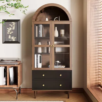 A wooden cabinet with glass doors and drawers, styled with decorative items and books, next to a record player console.