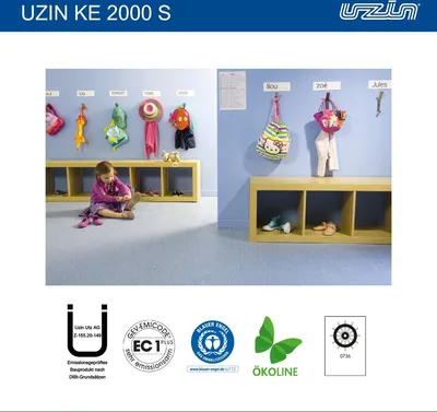 A child is putting on shoes in a room with cubbies and coat hooks.