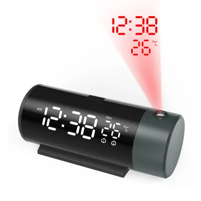 A black cylindrical digital alarm clock with a projected display of the time and temperature.