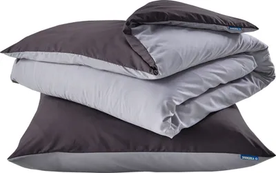 A stack of folded bedding, including a duvet cover and pillowcases, in dark gray and light gray.