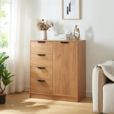 A wooden cabinet with drawers and a door, decorated with a vase of dried flowers and small sculptures, placed in a room with a sofa and a window with curtains.