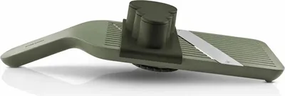 A green vegetable slicer is shown against a white background.