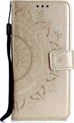 A close-up view of a gold-colored flip phone case with a mandala pattern embossed on it.