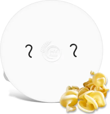A white circular object with a smiley face and a pile of rotini pasta in the foreground.