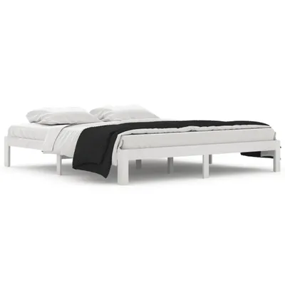 A white wooden bed frame with white bedding and a black blanket.
