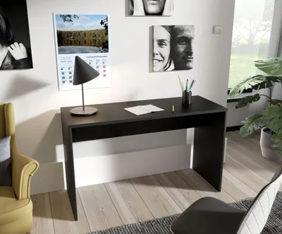 A modern home office setup with a black desk, chair, and decorative items.
